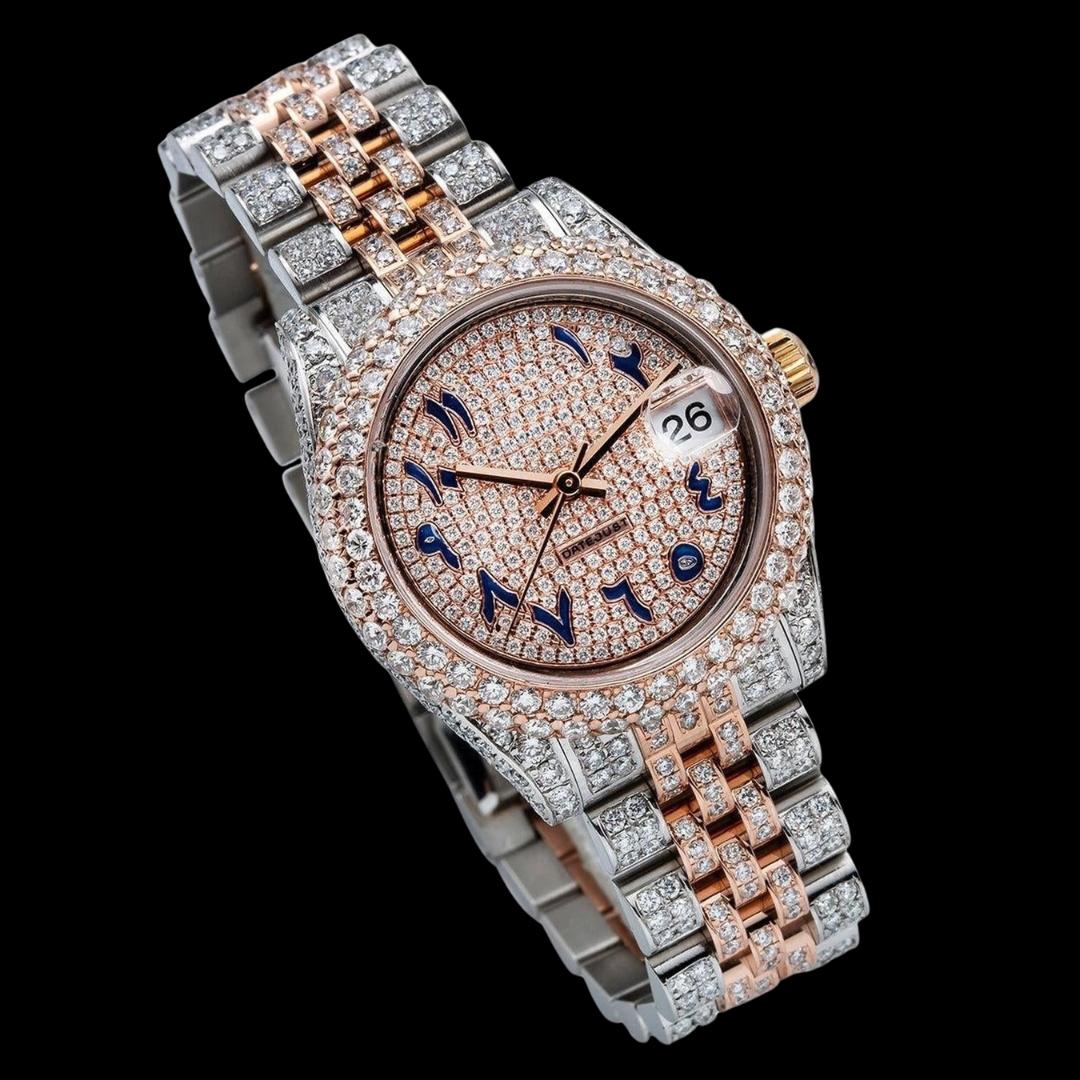 Rolex Rose Gold Diamond Paved Dial Blue Arabic Numerals Two Tone Jubilee Bracelet Iced Out Moissanite Watch Close Up Front View